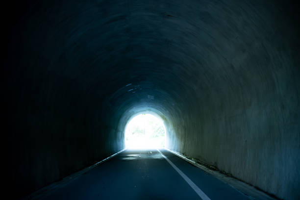 Deserted concrete tunnel leading to nature.