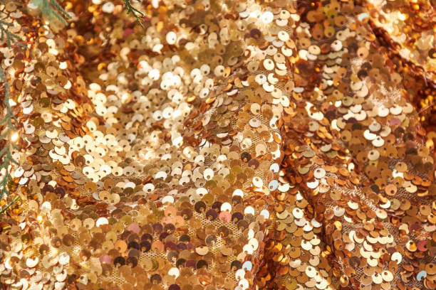 istock Waves of brightly shiny fabric with gold sequins 2172303672