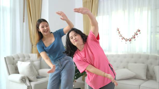 istock Two sister enjoys dancing together at home during the holidays 2172304166