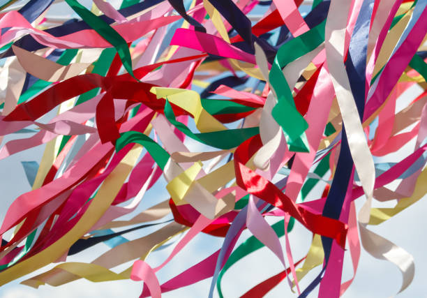 istock Multicolored festival ribbons flutter in the wind. Background 2172305428