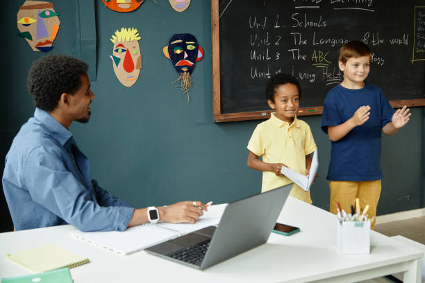 istock Two Schoolboys Answering at Blackboard while Lesson at Primary School 2172310274