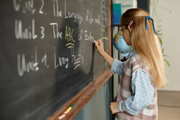 istock Female Student Writing on Blackboard during Ecology Lesson in Classroom 2172310280
