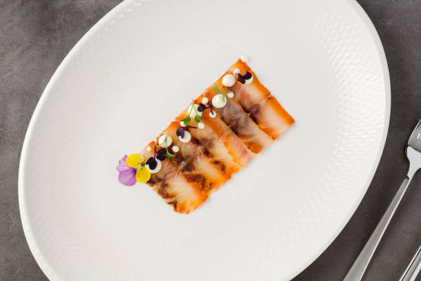 istock Smoked fish pastrami or bacon on a white porcelain plate 2172311342