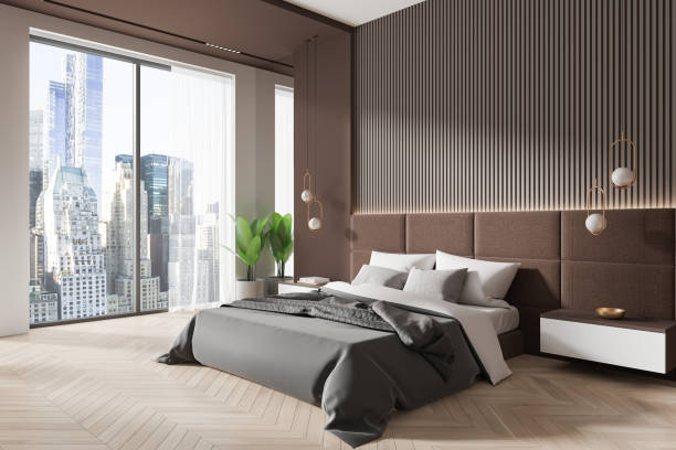 istock Brown home bedroom interior with bed and nightstand, panoramic window 2172313601