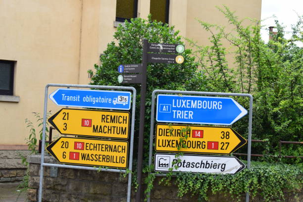 Road signs in French and German point to cities in Luxembourg and Germany, including Remich, Trier, and Luxembourg City.