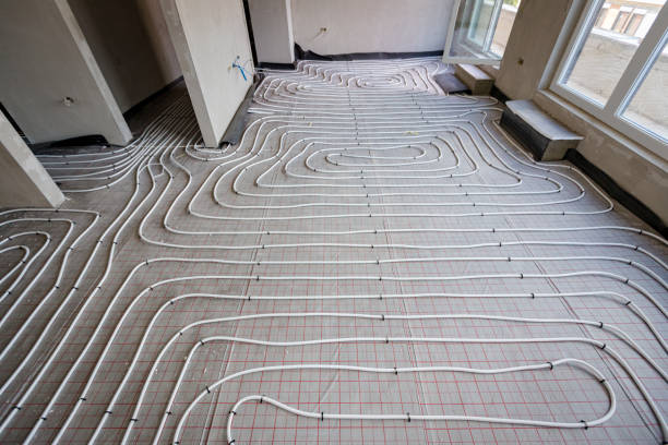 istock View on thin white tubes bended in complex curve of new brass, distribution system manifold mounted for central heating floor in a residential building under construction. 2172313750