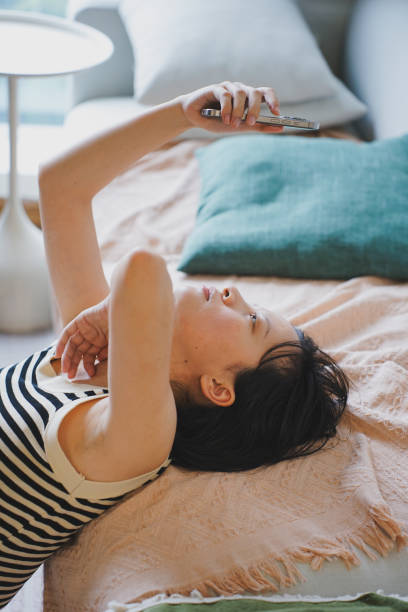istock Young Asian woman using smartphone at home 2172314774
