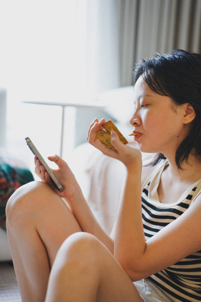 istock Young Asian woman using smartphone at home 2172314809