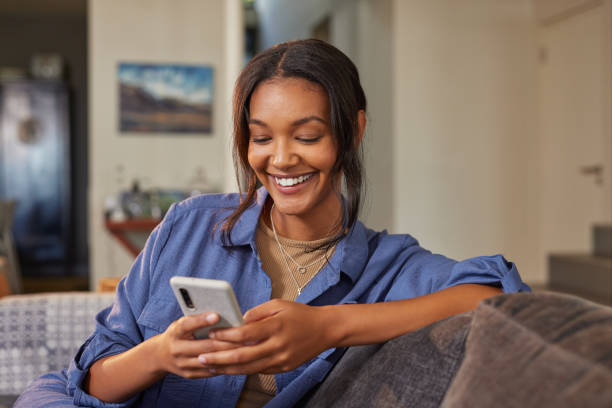 istock Beautiful multiethnic woman using phone at home 2172315608