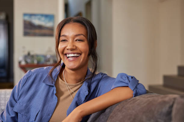 istock Laughing indian woman on sofa at home 2172315609