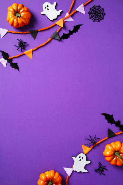 istock Halloween vertical flat lay composition with paper garland pumpkins, ghosts, spiders, bats on purple background. Happy Halloween poster template 2172315749