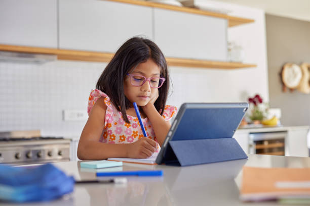istock Little indian girl studying on digital tablet 2172316556