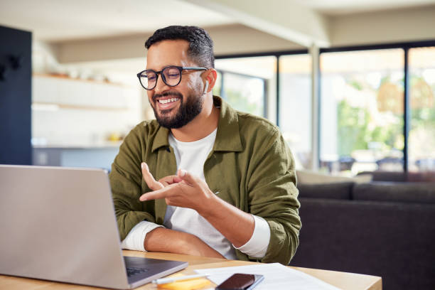 istock Hispanic man speaking on video call with laptop at home 2172317008