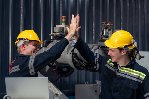 istock Engineer standing by robotic arm and operating machine in industry factory, technician worker check for repair maintenance electronic operation 2172317415