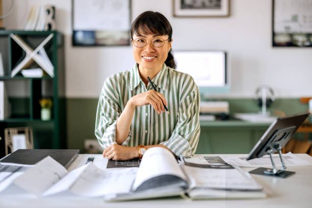 istock Beautiful female architect posing for a shot while working at home office 2172318375