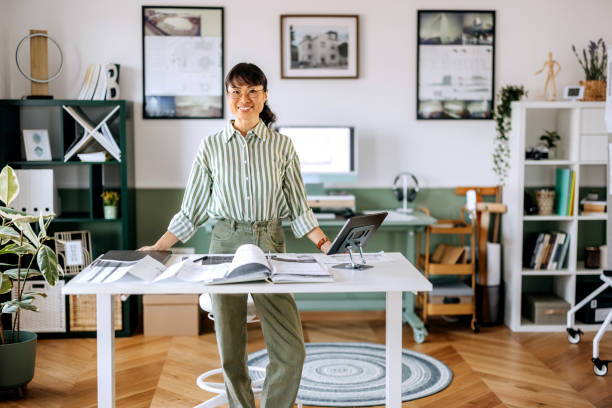 istock Beautiful female architect posing for a shot while working at home office 2172318414