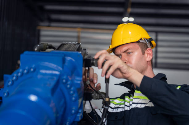istock Engineer standing by robotic arm and operating machine in industry factory, technician worker check for repair maintenance electronic operation 2172318431