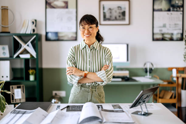 istock Beautiful female architect posing for a shot while working at home office 2172318466