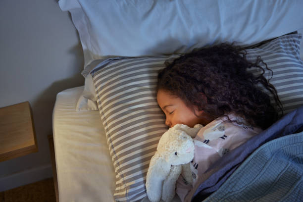 istock Lovely little girl sleeping peacefully during night 2172318501