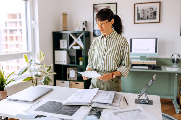 istock Female architect working at her home office 2172318792