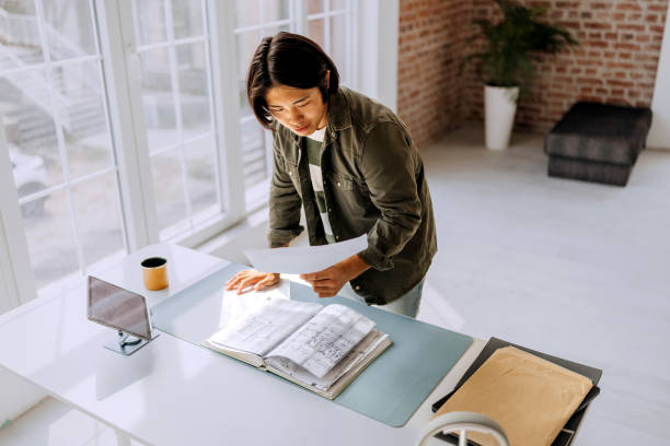 istock Casually clothed male architect analysing plan at modern minimalistic office 2172319078