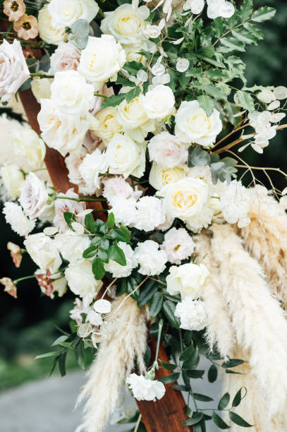 istock Wedding triangular arch with roses on the background of nature 2172319180