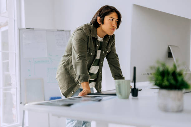 istock Young casually clothed man working on desktop PC at modern office 2172319188