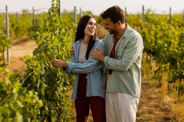 istock Couple enjoying a romantic stroll through lush vineyard rows on a sunny day, immersed in natureâs beauty and each otherâs company 2172319277