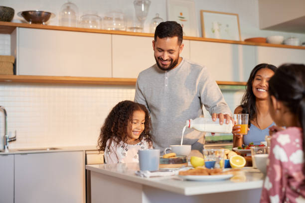 istock Father serving milk to her daughter during breakfast 2172319353