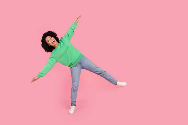 istock Full length photo of cheerful pretty lady dressed green pullover having fun arms sides empty space isolated pink color background 2172319375