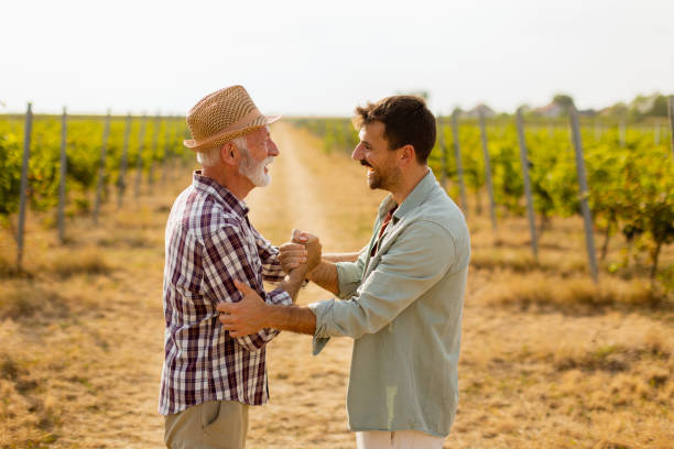 istock Heartfelt conversation between two generations in a sunlit vineyard during late afternoon harvest season 2172319881