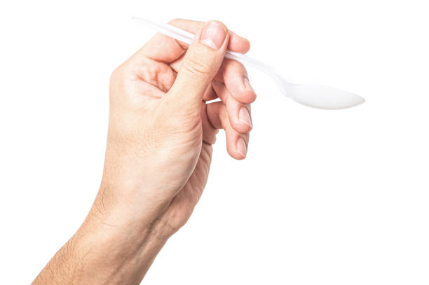 istock Male hand holding a white plastic spoon isolated on white background. 2172320030