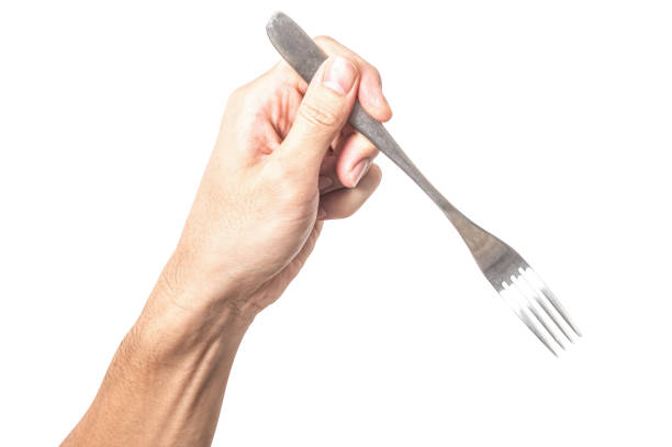 Male hand holding a silver steel fork isolated on white background.