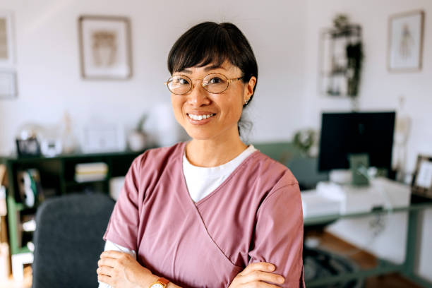 istock Smiling female doctor posing for camera at the office 2172320991