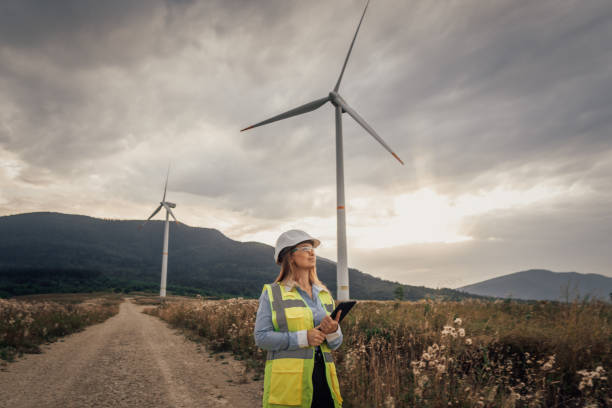 A dedicated female engineer is actively managing wind turbines as part of a significant renewable energy project aimed at promoting sustainable practices and innovative technology solutions