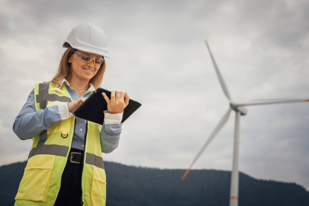 istock A highly skilled professional female engineer is working diligently at a wind turbine site, utilizing a tablet for precise monitoring and indepth analysis of the various operational parameters 2172321185