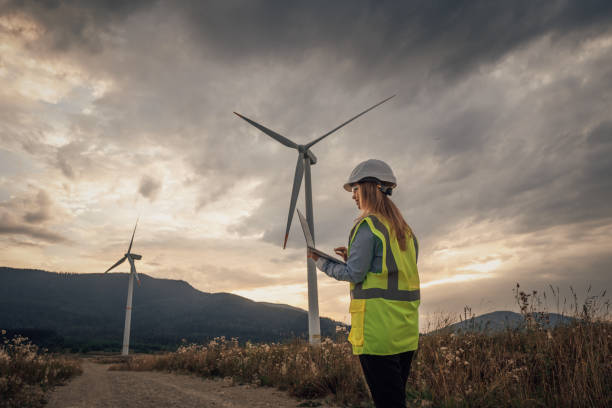 istock A Wind Energy Technician is meticulously inspecting a towering turbine set against a breathtaking scenic landscape, ensuring it operates efficiently and contributes to sustainable energy production 2172322036