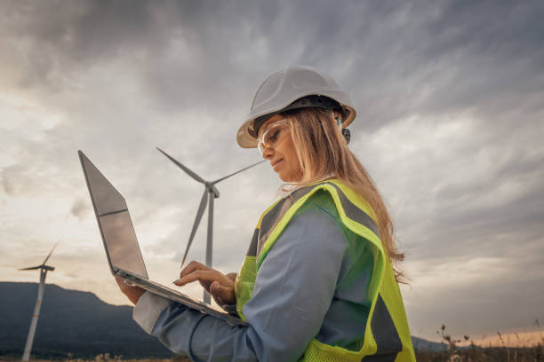 istock A skilled female engineer is conducting vital research at a modern wind farm, using advanced technology on her laptop to improve sustainability and drive innovation in engineering 2172322497
