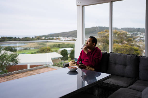 man drinking a cup of coffee outdoors