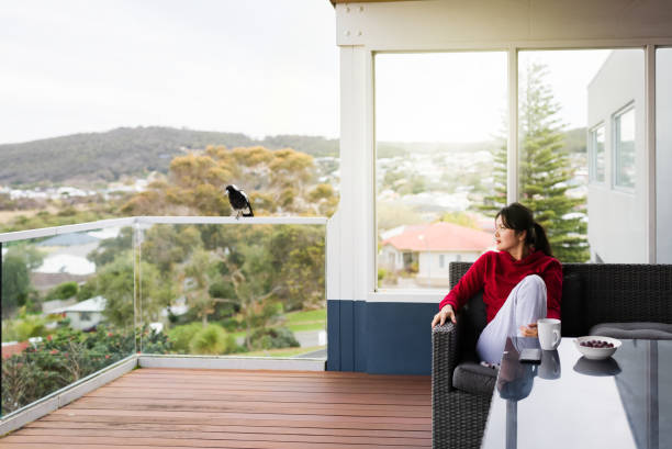 woman  watching bird in balcony
