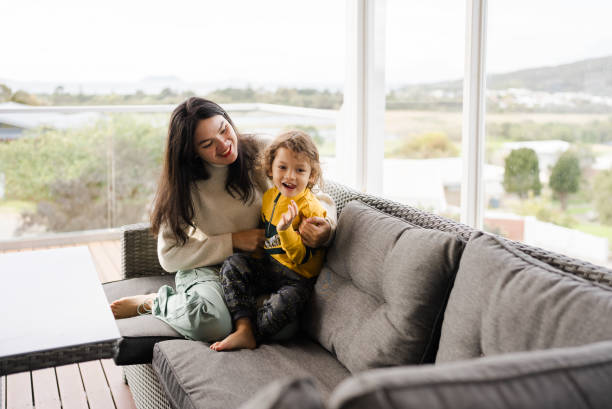 istock mother and son sitting on sofa in balcony 2172324964