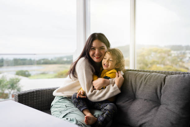 istock mother and son sitting on sofa in balcony 2172324975