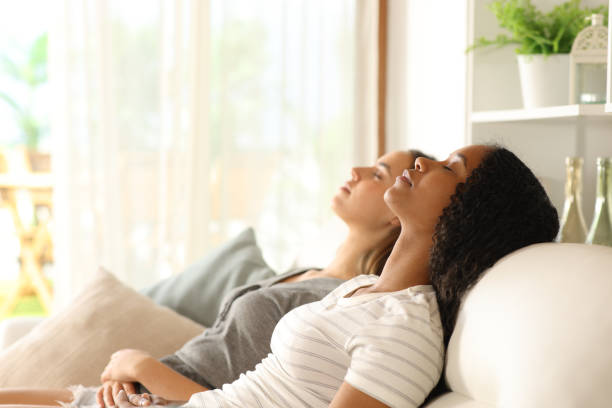 istock Interracial couple relaxing sitting on a couch 2172325254