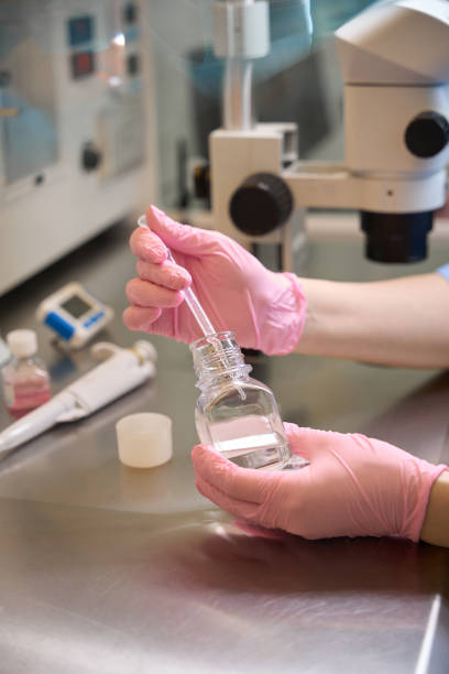 istock Adult embryologist preparing a solution in the lab 2172325653