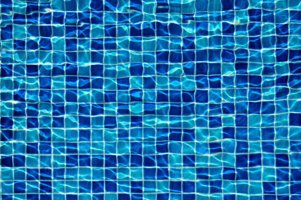 Overhead view of sun reflections on the water of a swimming pool.