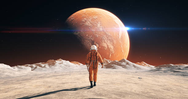 istock Male Astronaut In Space Suit Walking On Alien Planet. Planet Mars Is Visible. 2172326206