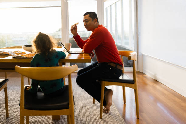 istock parent  looking onto laptop with kids 2172326340