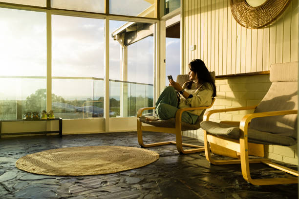 istock young Asian Chinese woman using smartphone at home 2172326378