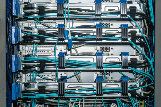 istock Back side of the network servers with ethernet and power cables  in the rack. Cable fastenings are visible 2172327377