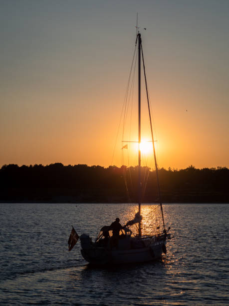 istock Backlit sailing yacht at sunset 2172327881